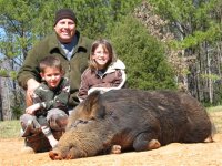 Me and the kids with a hog. Mar 2007.jpg