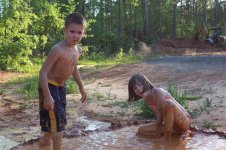 Kids making a mud pool, May 2006.jpg
