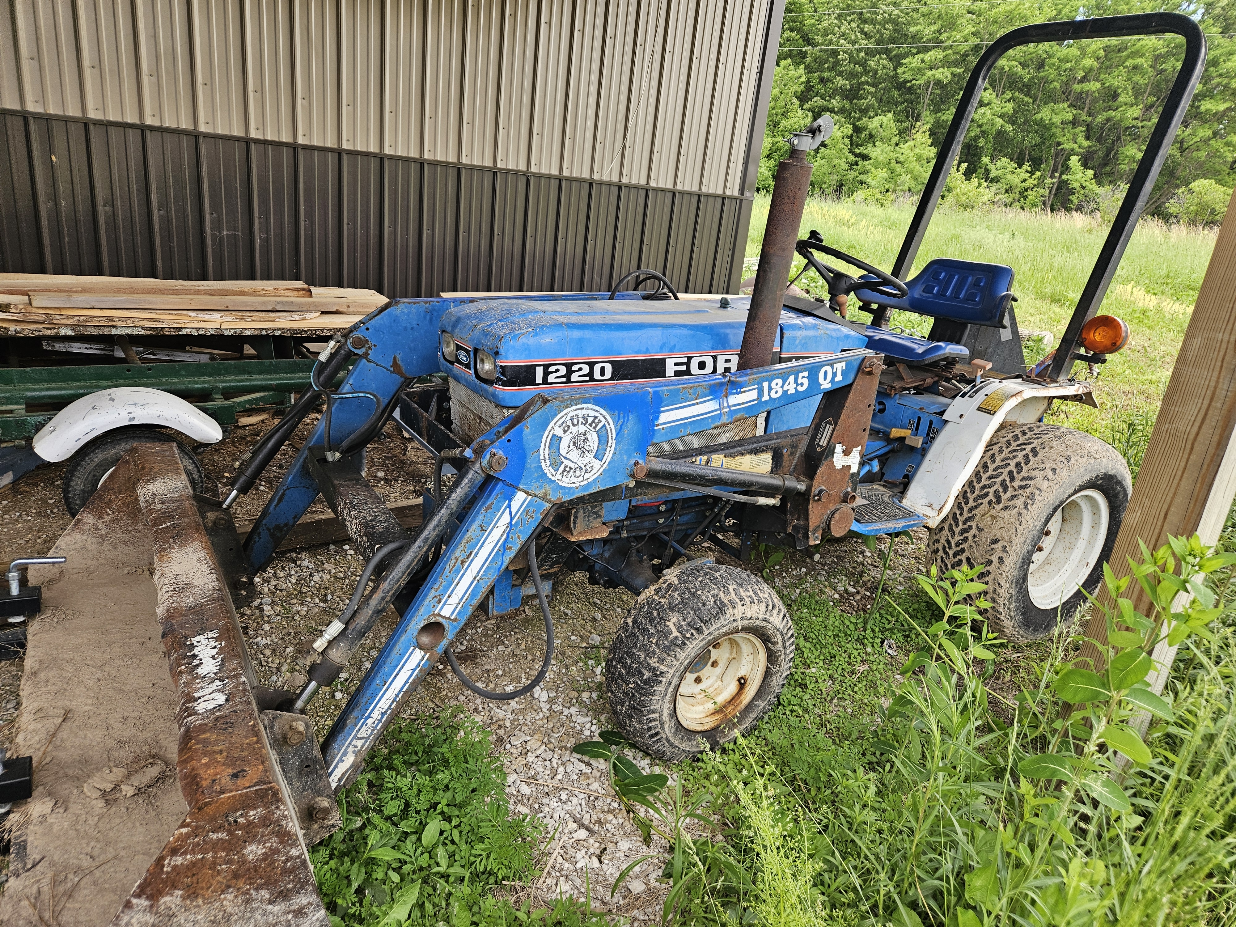 Ford 1220 4x4 W/loader and belly mower.