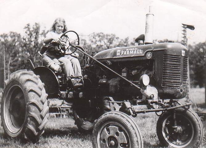 Elayne and James on tractor June 1956.jpg