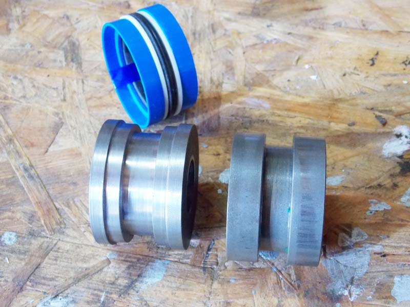 old piston, cut piston, new seal.jpg