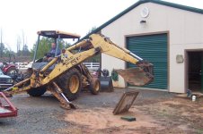 Backhoe setting the slab down.jpg