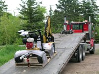 Backhoe delivered on tiltbed truck.JPG