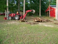 4-23-10 Stacking Cedar Logs.jpg