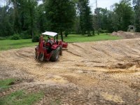 7-9-12 Big RED Beast going up dam with clay.jpg