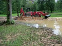 7-11-12 Big RED Beast eyeballing culvert location.jpg 7-11-12 Big RED Beast eyeballing culvert location.jpg