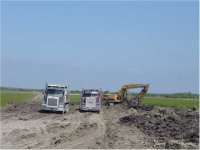 626419-DirtWorkDay2_TrackHoeAnd2TrucksInOperation2Small.jpg