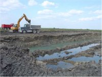 629457-050414DiggingOnNorthHalfOfPond.jpg