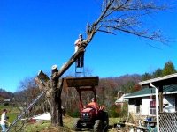 man-on-ladder-in-front-loader.jpg
