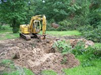 6-4-16 CAT mucking mud back into hole.jpg