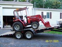 Tractor on trailer tilted.JPG
