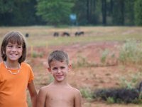 Kids with hogs behind them..jpg