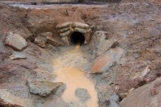 Culvert exit with water flowing.jpg