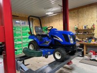 New Holland TZ18DA on lift.jpg