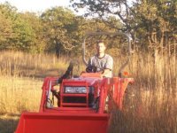 my_ugly_mug_on_a_fine_tractor.jpg