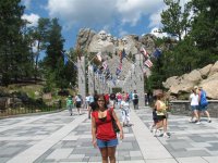 21 Steph in front of Mt Rushmore with the flags behind her.jpg