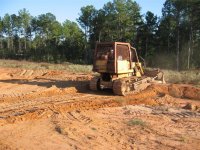 23  Don starting to dig my ditch to drain rain water to my lake.JPG