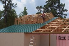Steph installing metal roofing.JPG